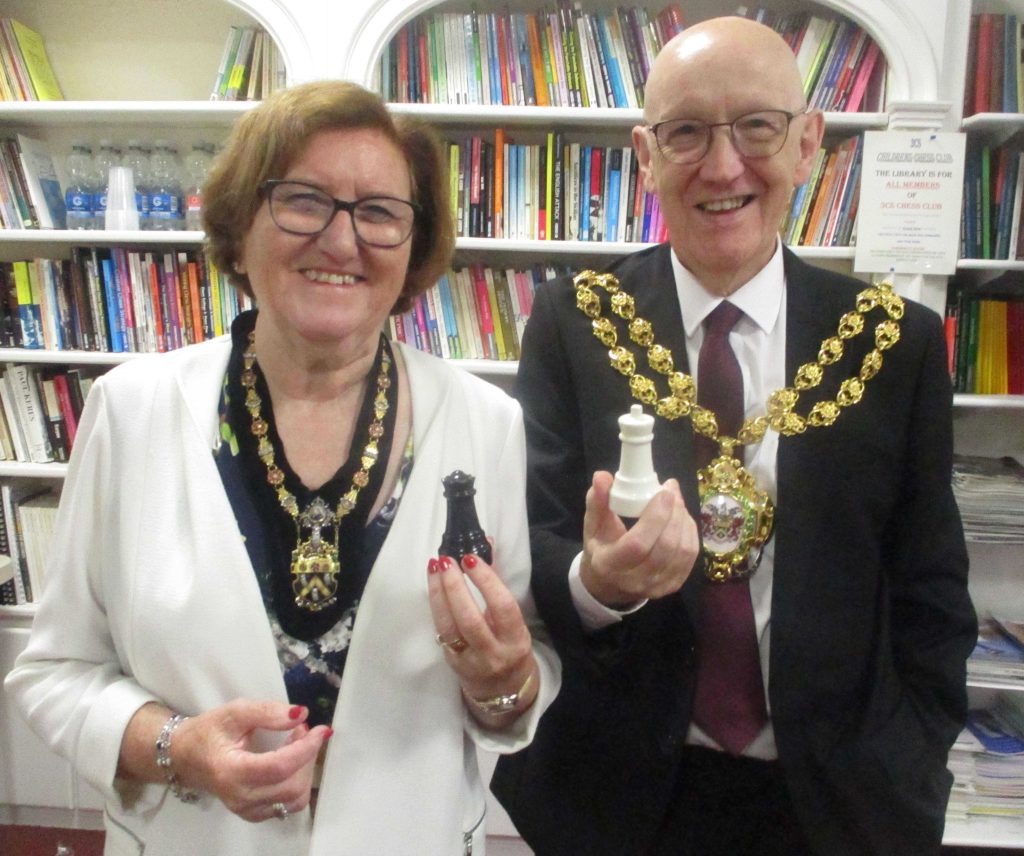 The Mayor and Mayoress with a King and Queen salt and pepper set as a remembrance of their visit to 3Cs chess club.